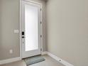 Clean, modern entryway featuring a white door with frosted glass panel and tiled flooring at 7870 W 43Rd Pl, Wheat Ridge, CO 80033