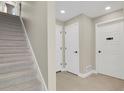 Hallway featuring staircase, neutral walls, modern white doors, and tile flooring at 7870 W 43Rd Pl, Wheat Ridge, CO 80033