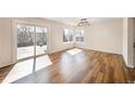 Open dining area featuring hardwood floors, natural light, and access to the outdoor deck at 18438 E Berry Dr, Centennial, CO 80015