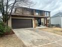 Two-story home with a two-car garage and traditional design elements in a suburban neighborhood at 18438 E Berry Dr, Centennial, CO 80015