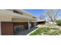 Close-up of the front porch with brick accents and a covered entryway at 8389 Benton Way, Arvada, CO 80003