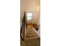 Carpeted staircase leading to an upper level, with black and wood railing at 8389 Benton Way, Arvada, CO 80003