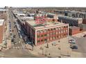 Wide aerial shot of the building with signage, showcasing its urban location and surrounding neighborhood at 2500 Walnut St # 201, Denver, CO 80205