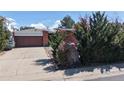 Charming brick ranch-style home with an attached garage and mature landscaping at 110 Forest St, Denver, CO 80220
