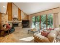 Inviting living room featuring a cozy brick fireplace and access to a lovely outdoor patio at 5063 E Otero Cir, Centennial, CO 80122