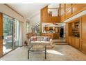 Spacious living room with a soaring ceiling, natural light, and an adjacent kitchen and dining area at 5063 E Otero Cir, Centennial, CO 80122