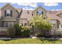 Charming townhome featuring stone accents, landscaped front yard, and a welcoming facade at 10183 Grove Loop # D, Westminster, CO 80031