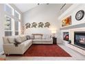 Bright living room featuring a fireplace, high ceilings, large windows and comfortable seating, perfect for relaxing and entertaining at 10183 Grove Loop # D, Westminster, CO 80031