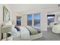 A bright bedroom with plush carpet with a view of the city from several windows, for an airy feel at 300 W 11Th Ave # 18C, Denver, CO 80204