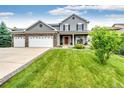 Two-story home boasts a well-manicured lawn, beautiful landscaping and a welcoming entrance at 12000 Horseshoe Ln, Parker, CO 80138