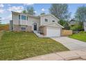 Two-story home with a well-maintained front yard and a two-car garage, perfect for suburban living at 3247 S Newland St, Denver, CO 80227