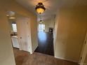 Inviting entryway with tile floors that flows into a spacious living area with vaulted ceilings and fireplace at 11304 Niagara St, Thornton, CO 80233