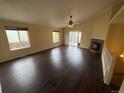 Bright and airy living room with hardwood floors, large windows, vaulted ceilings, and a fireplace at 11304 Niagara St, Thornton, CO 80233