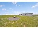 Expansive yard with fire pit, seating area, and views of the surrounding pasture at 4255 S County Road 185, Byers, CO 80103