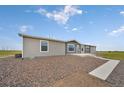 Newly renovated home featuring a modern exterior with gray siding and a well-maintained gravel yard at 4255 S County Road 185, Byers, CO 80103