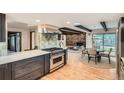 Modern kitchen with stainless steel appliances, a center island, and an open layout to the dining and Gathering room at 14030 E Progress Way, Aurora, CO 80015