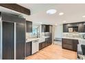 Bright kitchen with a farmhouse sink, updated appliances, and custom cabinetry, blending style and function at 14030 E Progress Way, Aurora, CO 80015