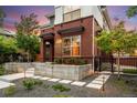 Brick home featuring manicured landscaping, modern architectural elements and welcoming front entrance at 3439 Uinta St, Denver, CO 80238