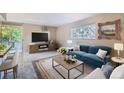 Cozy living room features a blue sofa, coffee table, and view to the outside at 937 N Clarkson St # 206, Denver, CO 80218