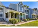 Inviting home with covered porch, lush greenery, and a charming facade at 19725 Rosewood Ct, Parker, CO 80138