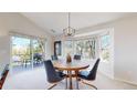 Bright dining area featuring a round table, stylish chairs, modern light fixture, and sliding door to outdoor deck at 6226 Quartz Loop, Arvada, CO 80403