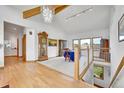 Bright dining area boasting a vaulted ceiling, hardwood floors, and a decorative chandelier at 3794 N State Highway 67, Sedalia, CO 80135