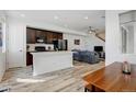 Bright open concept living space with a kitchen island, stainless steel appliances, and modern finishes at 9667 Walden St, Commerce City, CO 80022