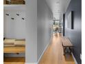 Stylish hallway showcasing hardwood floors, built-in bench, and modern wall decor at 1750 Wewatta St # 830, Denver, CO 80202