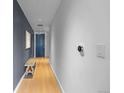 Clean, modern hallway with hardwood floors, and a stylish accent wall at 1750 Wewatta St # 830, Denver, CO 80202