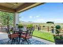 Covered patio area complete with mountain views, outdoor seating, and beautiful flowers at 19429 W 88Th Dr, Arvada, CO 80007
