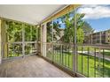 Enclosed outdoor patio with a view of the green lawn and surrounding buildings at 3082 S Wheeling Way # 202, Aurora, CO 80014
