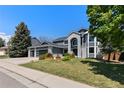 Charming two-story home with a three car garage, landscaped yard, and a modern exterior design at 9382 Lark Sparrow Dr, Highlands Ranch, CO 80126