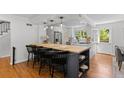Open kitchen design with island seating, modern lighting, hardwood floors and stainless appliances at 400 Holly St, Denver, CO 80220