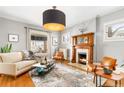 Cozy living room featuring a fireplace, large windows, and comfortable seating at 3701 Eliot St, Denver, CO 80211