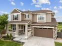 Charming two-story home with a well-manicured lawn, inviting porch, and a two-car garage at 3620 Sandoval St, Brighton, CO 80601