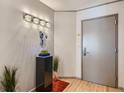 Bright entryway with hardwood floors, modern light fixture and art piece at 1777 Larimer St # 1908, Denver, CO 80202