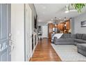 Inviting open-concept living space featuring hardwood floors, modern lighting, and a seamless flow to the kitchen at 16031 W 63Rd Ln # D, Arvada, CO 80403