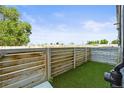 Backyard featuring artificial grass and horizontal wood fence at 4737 E Iliff Ave, Denver, CO 80222