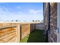 Backyard featuring artificial turf and a wooden fence, providing a private outdoor space at 4737 E Iliff Ave, Denver, CO 80222