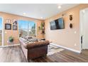 Cozy living room with a large window, hardwood floors, and stylish decor at 8552 W San Juan Ave, Littleton, CO 80128