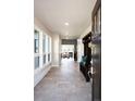 Bright entryway featuring neutral walls, tile flooring and bench with coat rack at 6491 Crestbrook Dr, Morrison, CO 80465