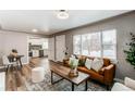Bright living room featuring a stylish leather sofa with an open view to the renovated kitchen area at 808 Hanover St, Aurora, CO 80010