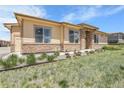 Inviting exterior of home featuring stone accents, lush lawn and well-maintained landscaping at 12258 Hazel Spruce Ct, Parker, CO 80134