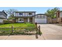 Beautiful two-story home with a stone facade, well-kept lawn, and an attached two car garage at 8897 Wagner Ln, Westminster, CO 80031