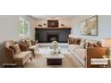 Staged living room featuring a fireplace, comfortable seating, and stylish decor at 8897 Wagner Ln, Westminster, CO 80031