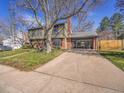 Two-story home with red brick accents and a modern glass door two-car garage at 3766 E Easter S Cir, Centennial, CO 80122