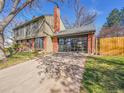 This house has a modern glass garage door and classic brick accents at 3766 E Easter S Cir, Centennial, CO 80122