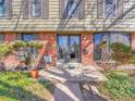 Close-up of the front porch of this home with classic brick and nice landscaping at 3766 E Easter S Cir, Centennial, CO 80122