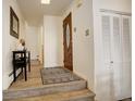 Hallway featuring beautiful front door, wood floors, and coat closet at 2378 Hearth Dr # 6, Evergreen, CO 80439