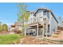 Relaxing backyard oasis features a spiral staircase and a covered patio with a hot tub at 9371 Desert Willow Trl, Highlands Ranch, CO 80129